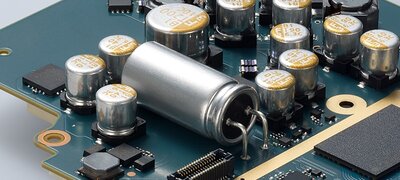 Large, solid high-polymer capacitor