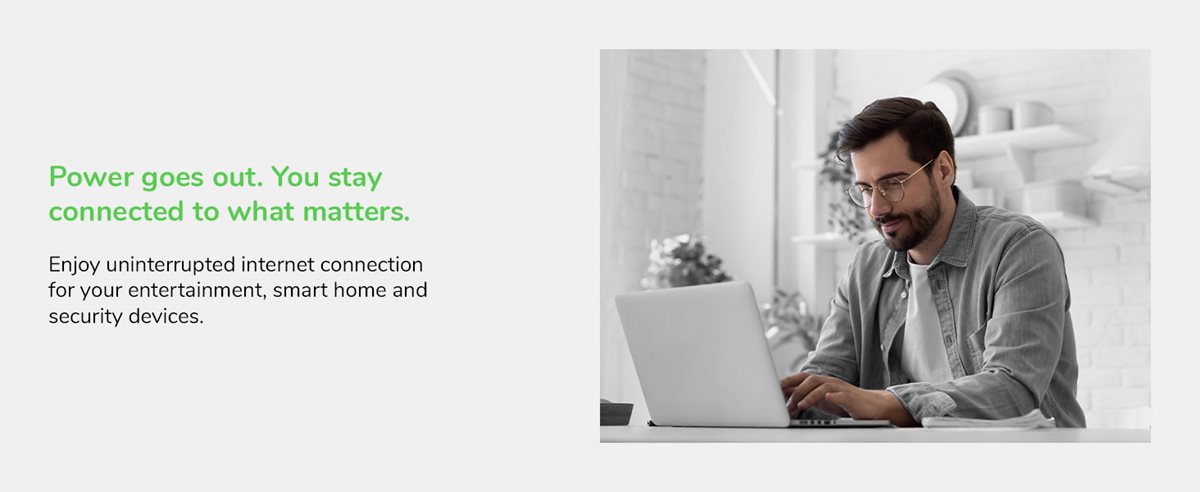 Man sitting at a table with a laptop.