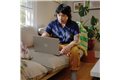 slide 9 of 10, zoom in, man uses his hp laptop on the couch