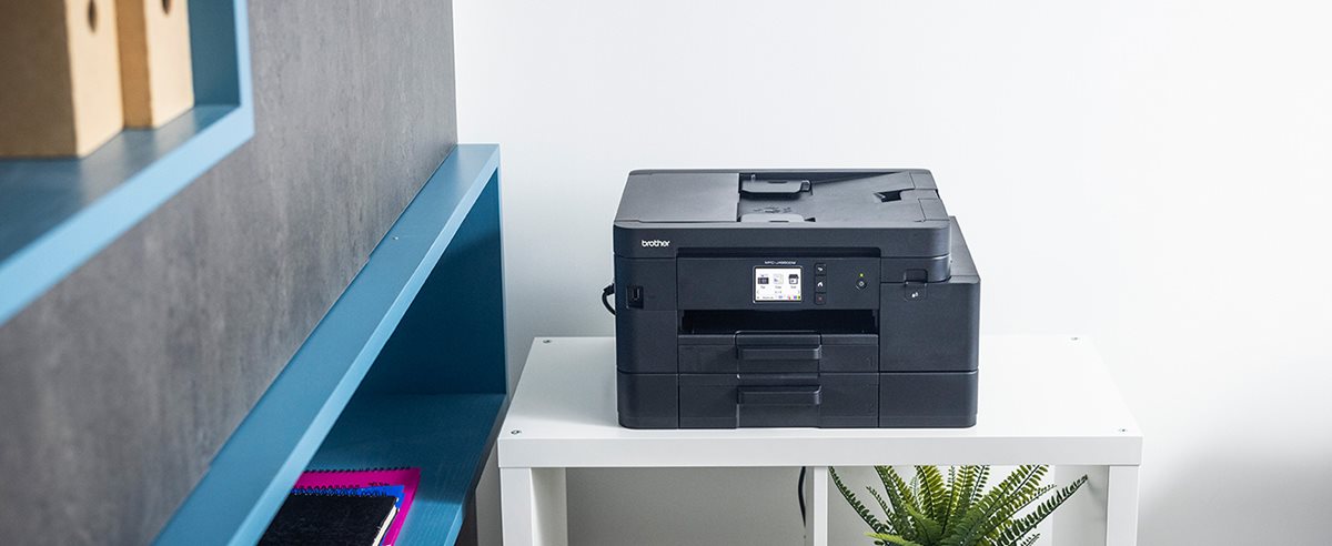 Brother MFC-J4550DW on a shelving unit in a home office environment