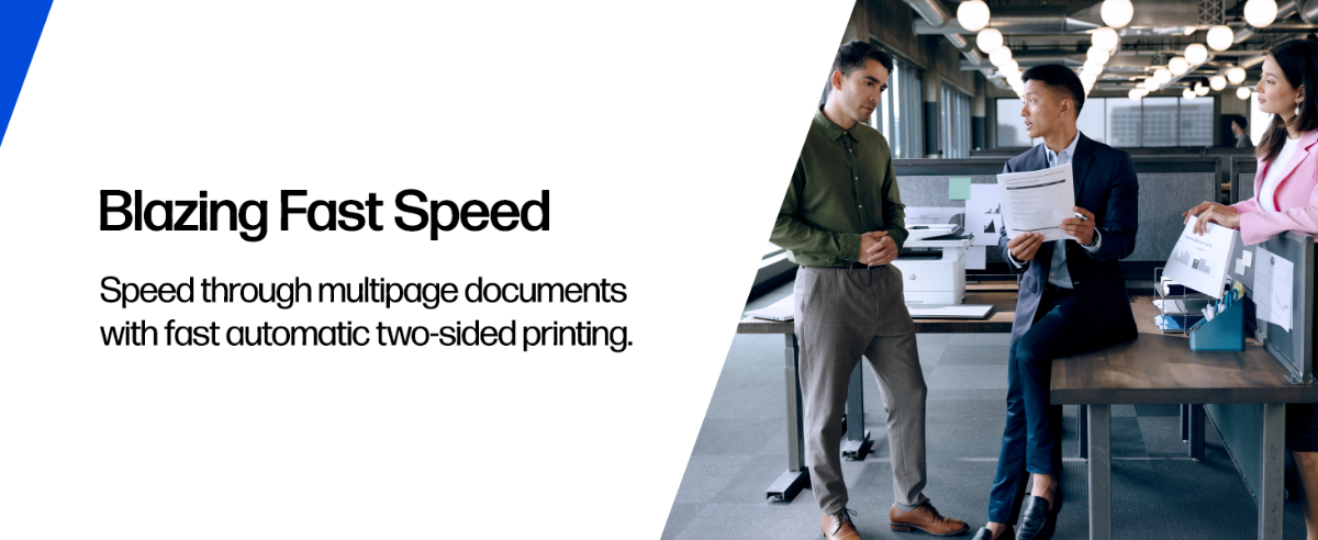 Professionals discussing a print near an HP laser printer in an office.