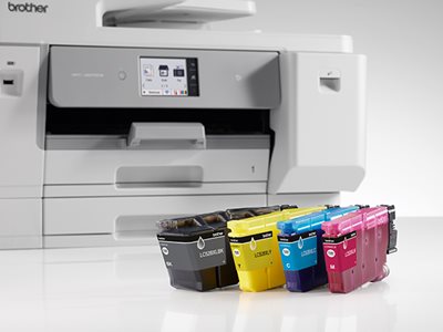 A Brother MFC-J6975DW with four ink cartridges in the foreground