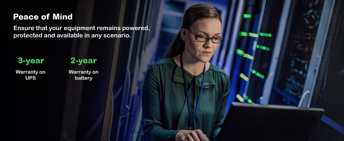 Woman working in a server room on laptop