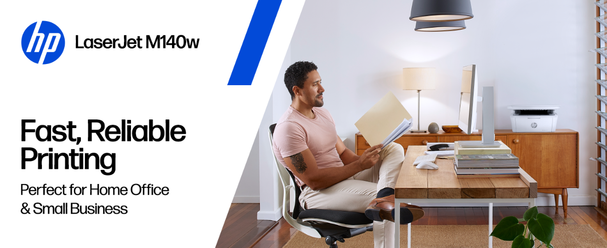 A person reviewing documents in a home office with an HP LaserJet M140w printer.