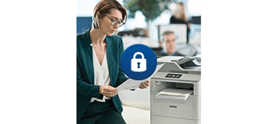 Woman reviewing printed documents at office printing station. With blue security lock icon