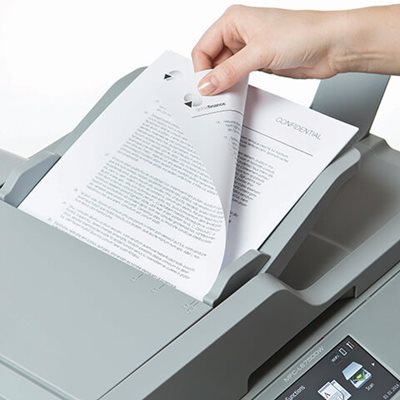 Person adding multi-page double-sided document into printer's automatic document feed for scanning