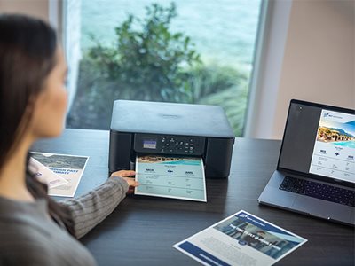 A woman removing print output from the Brother DCP-J1310DW