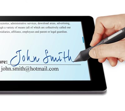 someone signing their name on the line on a document on screen with the pen