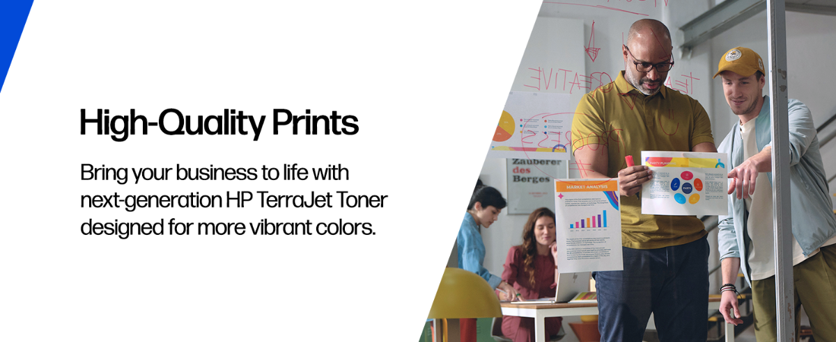 A team reviewing vibrant color prints in an office.