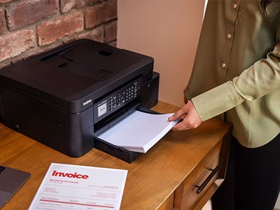 A woman using the Brother MFC-J4350DW front loading paper tray