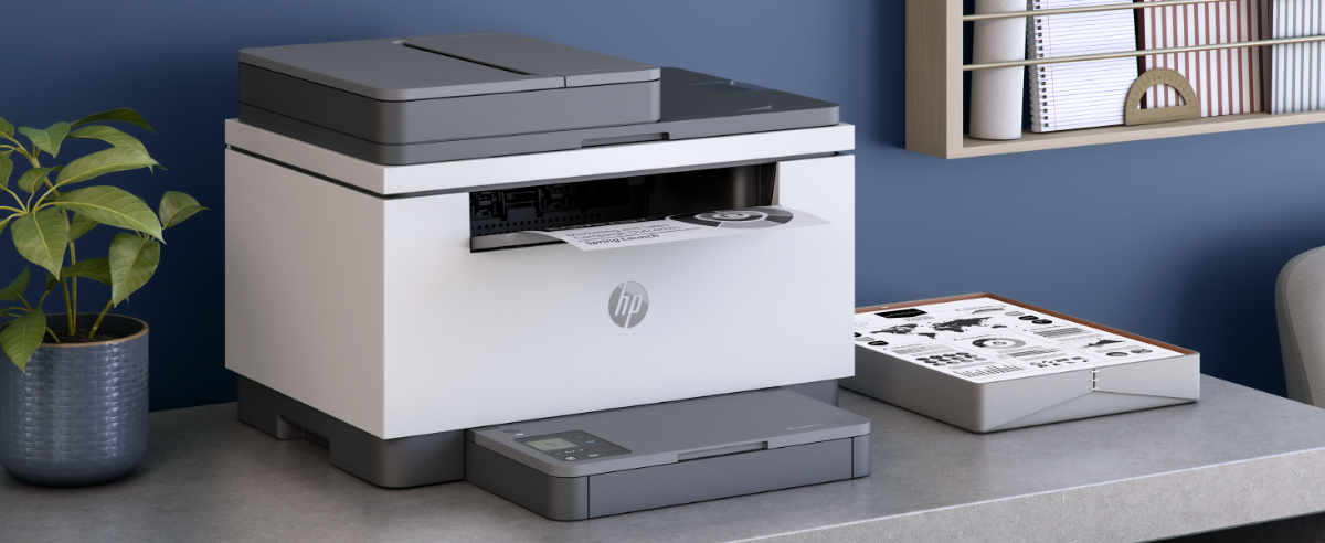 An HP LaserJet printer outputting a document on a desk.