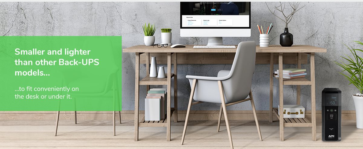 APC Back-UPS Pro BN1500M2 sitting on the floor underneath a desk with a computer.