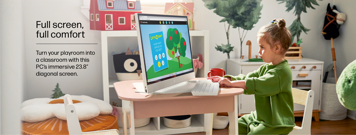 A young child is using the HP 23.8" All-in-One Desktop PC for educational purposes.
