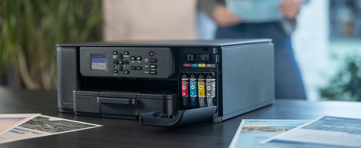 Brother DCP-J1310DW on a desk with ink cartridge door open
