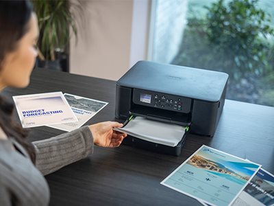 A woman using the Brother DCP-J1310DW front loading paper tray