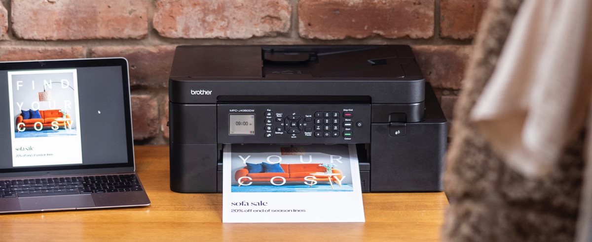 Brother MFC-J4350DW on a desk next to a notebook computer