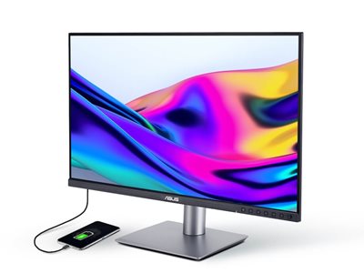 A sleek ProArt monitor displays vibrant, colorful abstract art. A smartphone, charging via a cable.