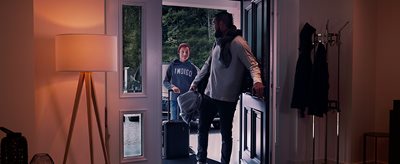Man and boy entering a house