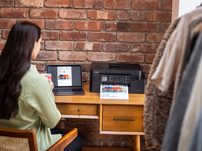 A woman using a notebook computer to print over Wi-Fi