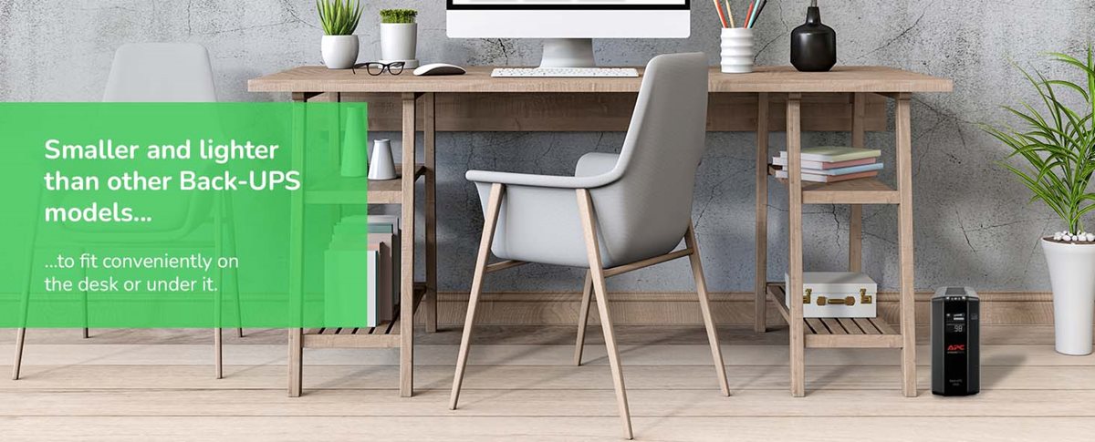 APC Back-UPS Pro BN1050M sitting on the floor underneath a desk with a computer.