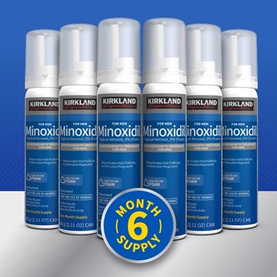 6 Kirkland Signature Minoxidil Foam Aerosol cans lined up with a 6 Month Supply badge ontop