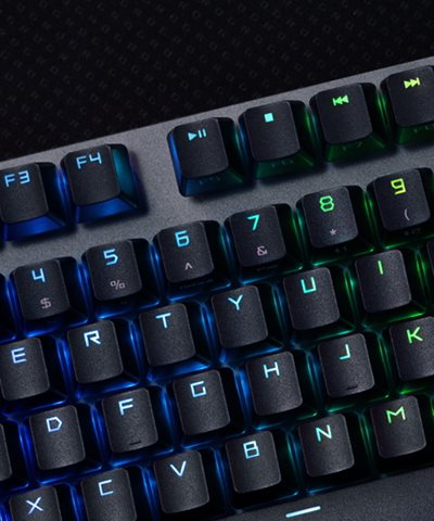 A close-up shot of the keys of the ROG Strix Scope NX Wireless Deluxe, showing rainbow RGB colours shining through the keycaps