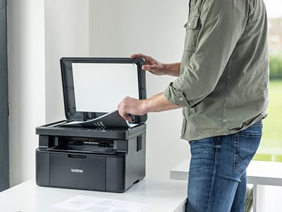 A man using the Brother DCP-L1640W scan function