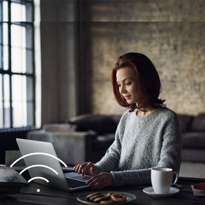 Female working in a small business or home office through Wifi.