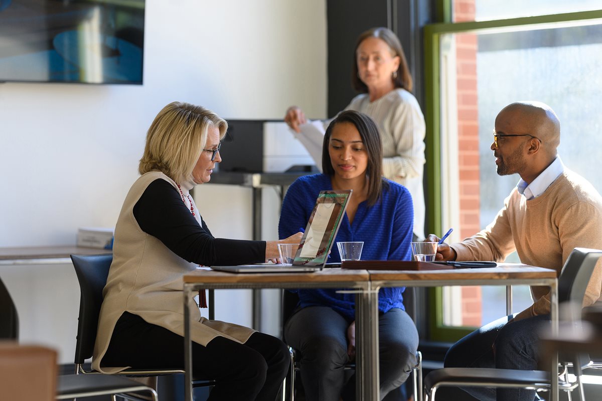 A group of people working in the meeting room