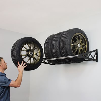 Person loading tire onto shelf