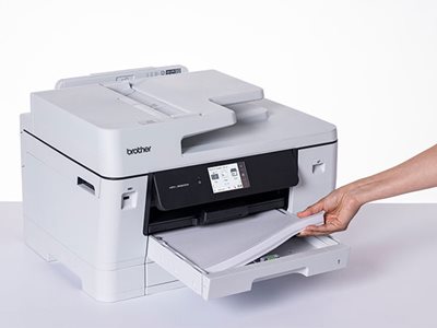 Close-up of a person inserting A3 paper into a Brother MFC-J6960DW paper input tray