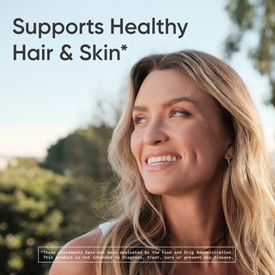 Image of a smiling woman outside. Text reads: "Supports healthy hair and skin*." With a footnote that reads: “*These statements have not been evaluated by the Food and Drug Administration. This product is not intended to diagnose, treat, cure, or prevent any disease."