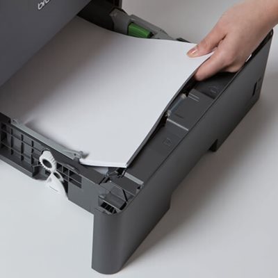 Person adding more paper to printer's paper tray