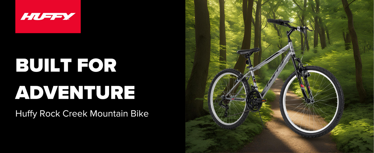 Huffy Rock Creek Mountain Bike in a woody background that is dark and shadowy