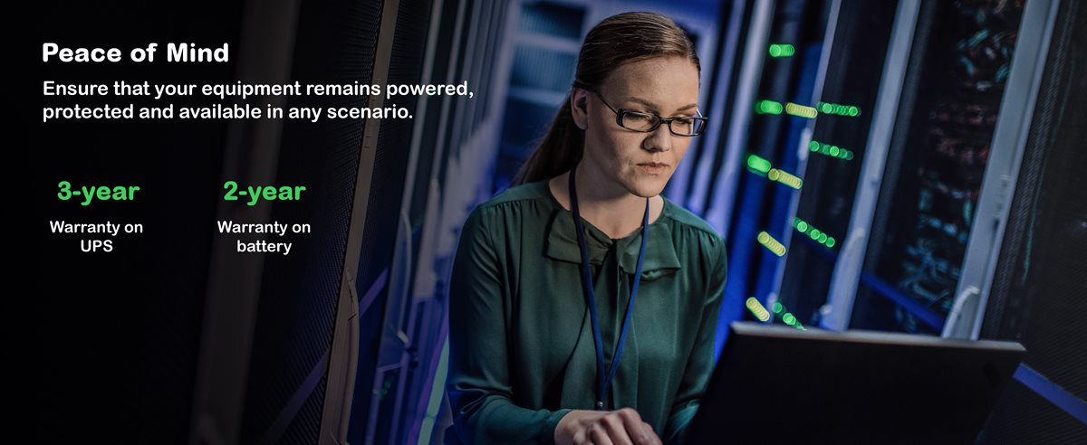 Woman working in a server room on laptop