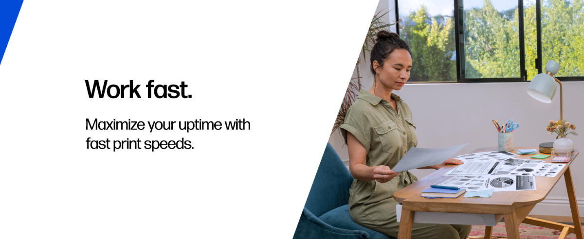 A person reviewing printed documents in a home office.