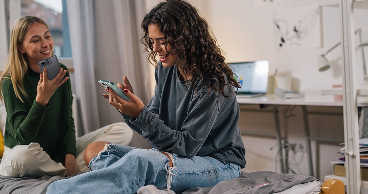 College students using smartphones and staying connected in their dorm room.