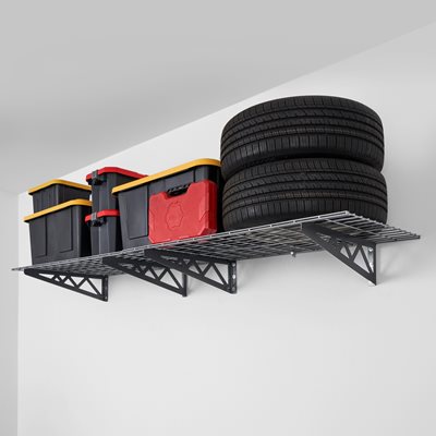 SafeRacks Wall Mounted Shelves mounted on a wall with 2 tires, storage bins, & other items on the shelves.