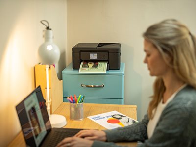 A woman using a notebook computer to print over Wi-Fi