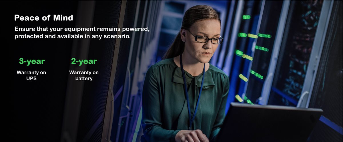 Woman working in a server room on laptop