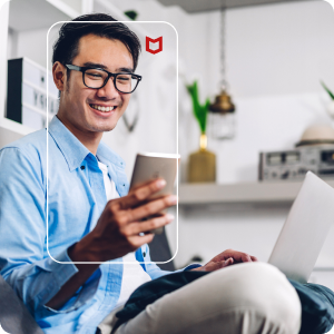 Man using cellphone and laptop
