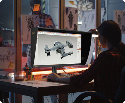 A creator working on the ProArt Display, sketching a futuristic spaceship concept.
