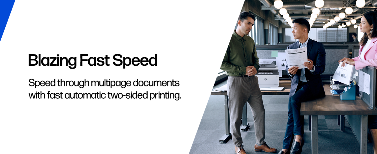 Professionals discussing a print near an HP laser printer in an office.
