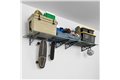 slide 3 of 10, zoom in, saferacks wall mounted garage shelving filled with storage bins, large tools, a cooler, 2 tires, and a skateboards and a helmet hanging from the accessory hooks.