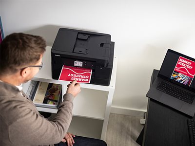 A man removing print output from the Brother MFC-J4550DW