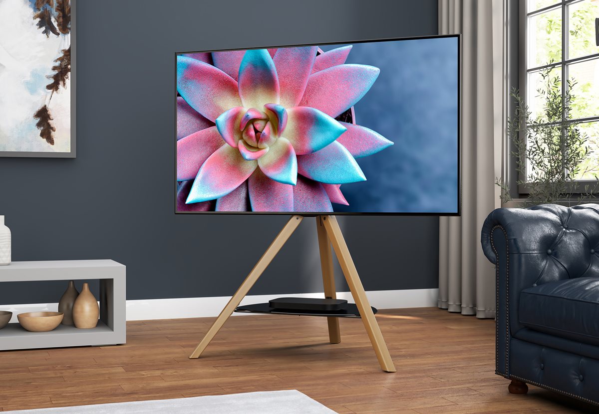 Stylish modern room featuring a large TV on a tripod-style TV Stand, with a glass shelf between the legs holding a DVD player