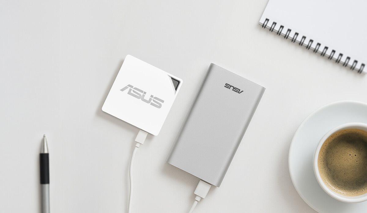 On the desk, there is coffee, a notebook and a pen, and an RT-AX50 Go powered by a portable charger.