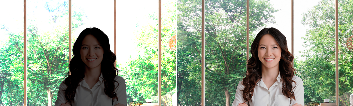 Billede af smilende kvinde med armene over kors, som har en hvid skjorte på i et lyst rum.