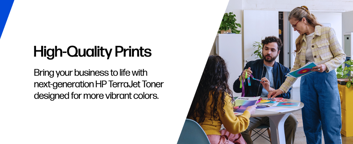 A team reviewing vibrant color prints in an office.