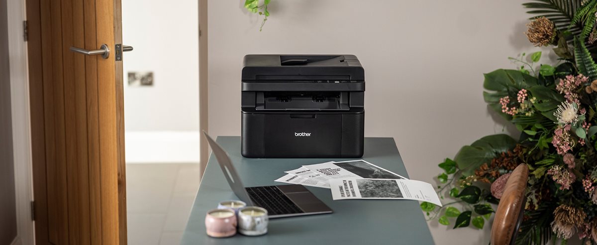 Brother DCP-L1660W on a desk in a home office environment